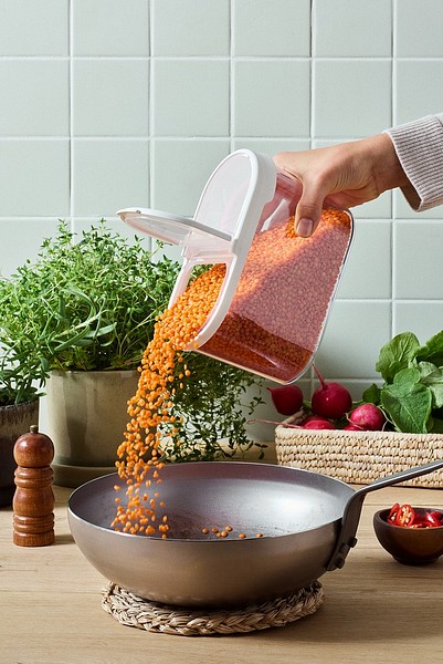 Pouring lentils to pan from SmartStore Flip dry food keeper